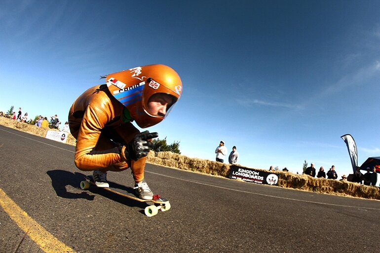 Feet are glued to the board as riders apex the tight, right corner. Blink and you'll miss them.