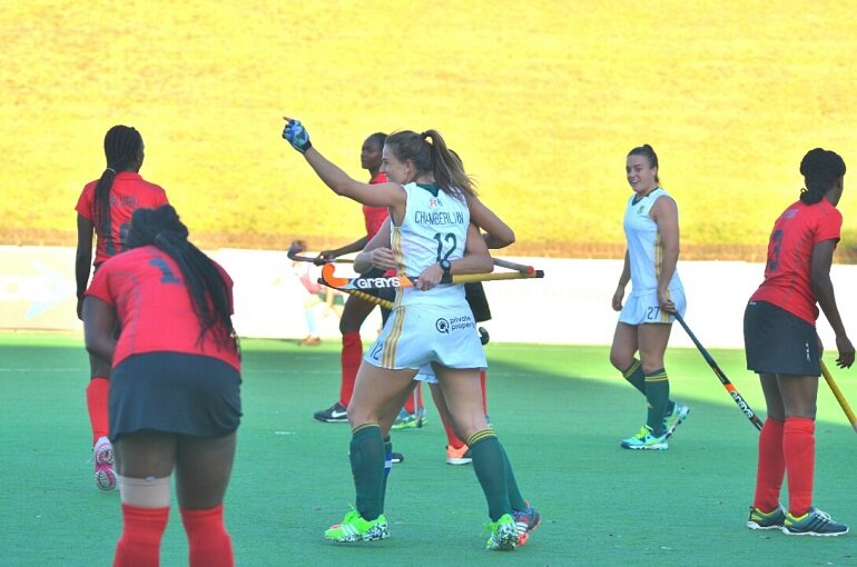 Goalscorer Dirkie Chamberlain (12) is embraced by SA captain Nicolene Terblanche (obscured) as Jade Mayne (27) looks on during the Greenfields Africa Hockey Championships match against Kenya at Randburg Hockey Stadium Thursday.